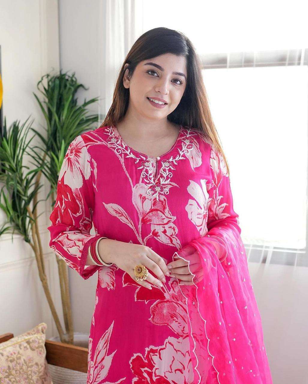 outfit consists of a long flowing kurta a matching bottom and a sheer dupatta